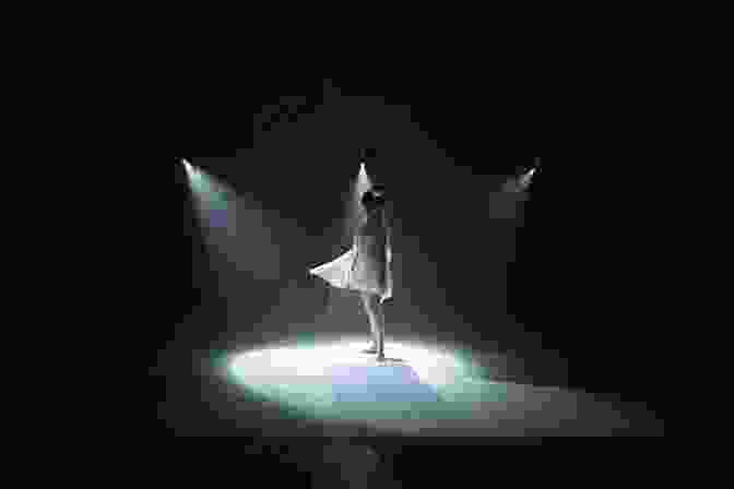 A Dancer Is Illuminated By A Single Spotlight, Casting A Dramatic Shadow On The Stage Behind Her. Dance S Duet With The Camera: Motion Pictures