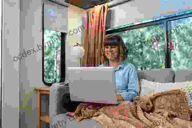 A Smiling Woman Sits Inside Her RV, Working On Her Laptop With A Scenic View Of The Mountains In The Background. Remote Work And Cheap RV Living: A Solo Woman S Journey Of Working Remote Traveling And Living Full Time In An RV While Preparing For Early Retirement