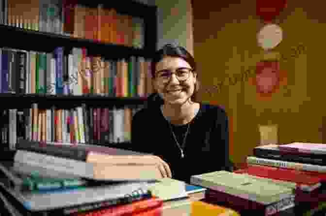 Author Sarah Miller, Smiling And Surrounded By Books Plain Wisdom: An Invitation Into An Amish Home And The Hearts Of Two Women