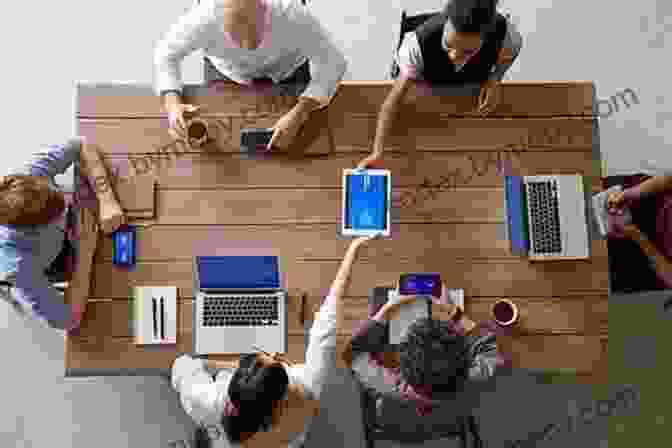 Group Of Men Gathered Around A Table, Working On A Project. The Ambuja Story: How A Group Of Ordinary Men Created An Extraordinary Company