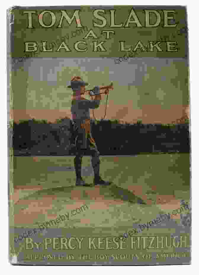 Tom Slade At Black Lake Book Cover, Depicting A Young Man Standing On A Rocky Shore With A Lake And Mountains In The Background Tom Slade At Black Lake